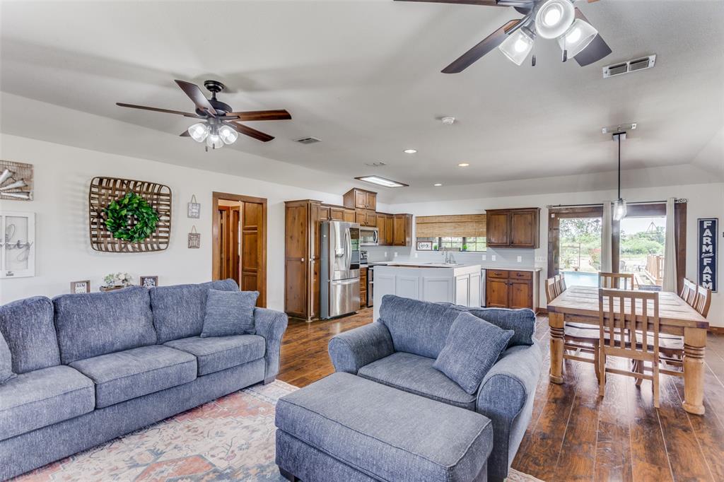 950 Johnson Bend Road Weatherford, TX 76088 - Photo 9 of 40 a living room with furniture ceiling fan and a large window