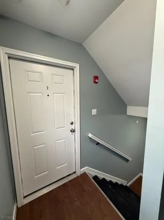 a view of an empty room and staircase