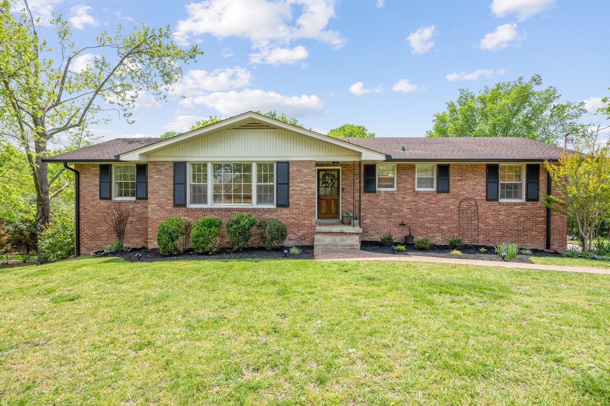 a front view of a house with a garden