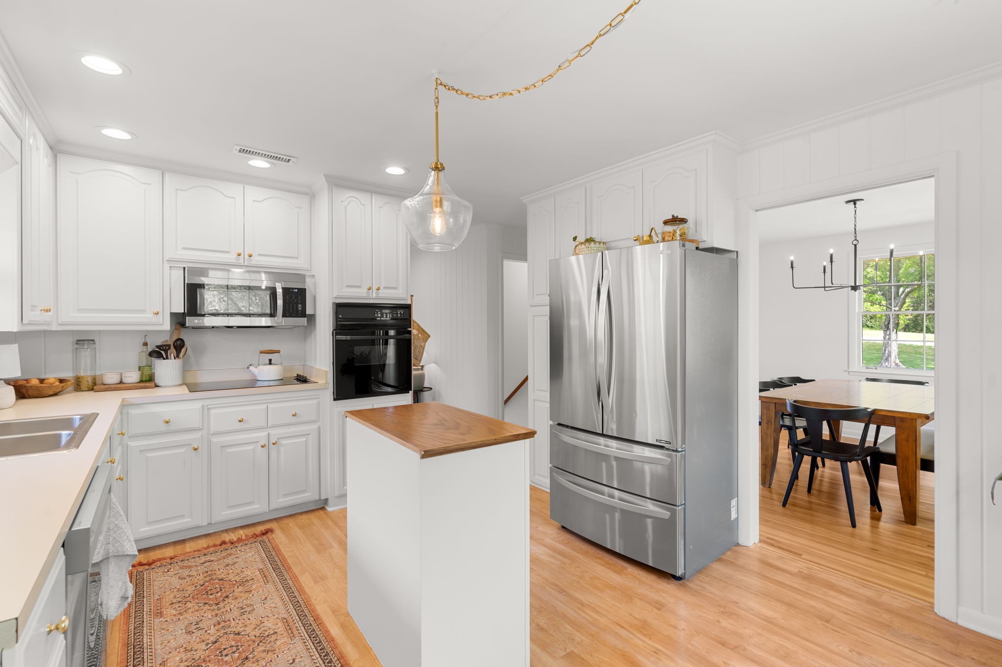 705 Vanoke Drive Madison, TN 37115 - Photo 10 of 40 a kitchen with stainless steel appliances granite countertop a refrigerator a stove a sink and a dining table with wooden floor