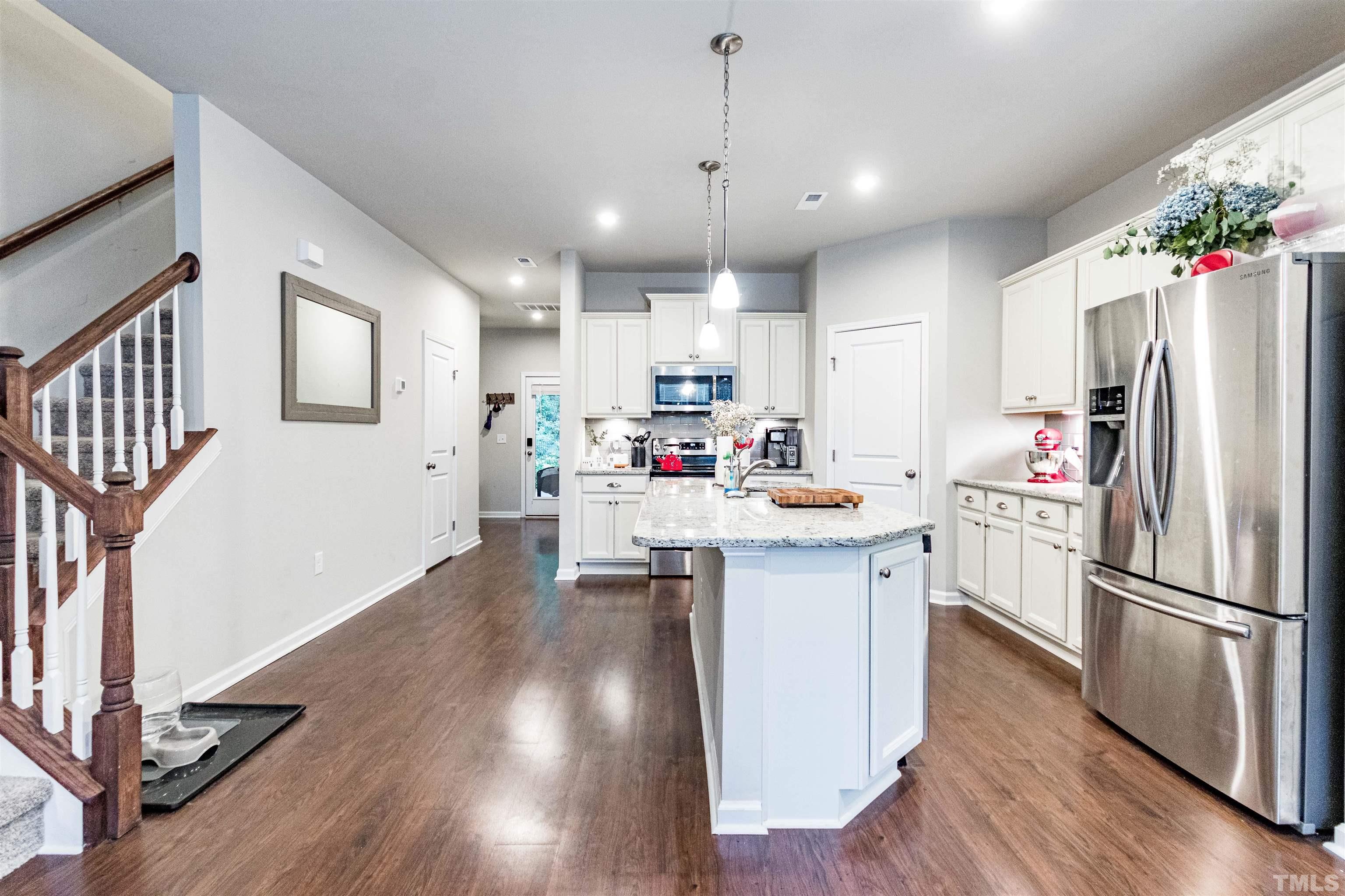3702 Buffaloe Road Raleigh, NC 27604 - Photo 4 of 13 a kitchen with stainless steel appliances granite countertop a refrigerator a stove top oven a sink dishwasher and a refrigerator with wooden floor