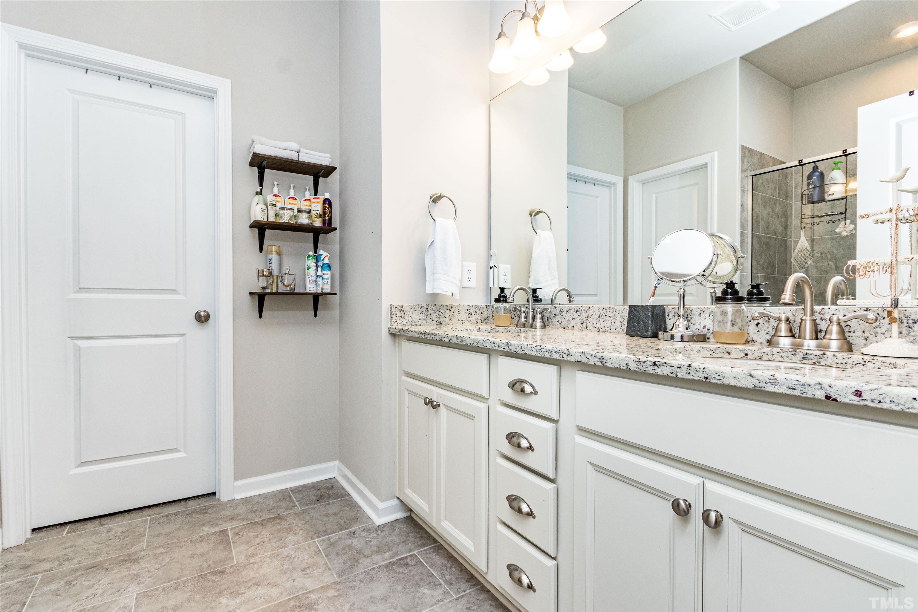 3702 Buffaloe Road Raleigh, NC 27604 - Photo 9 of 13 a bathroom with a sink and a mirror