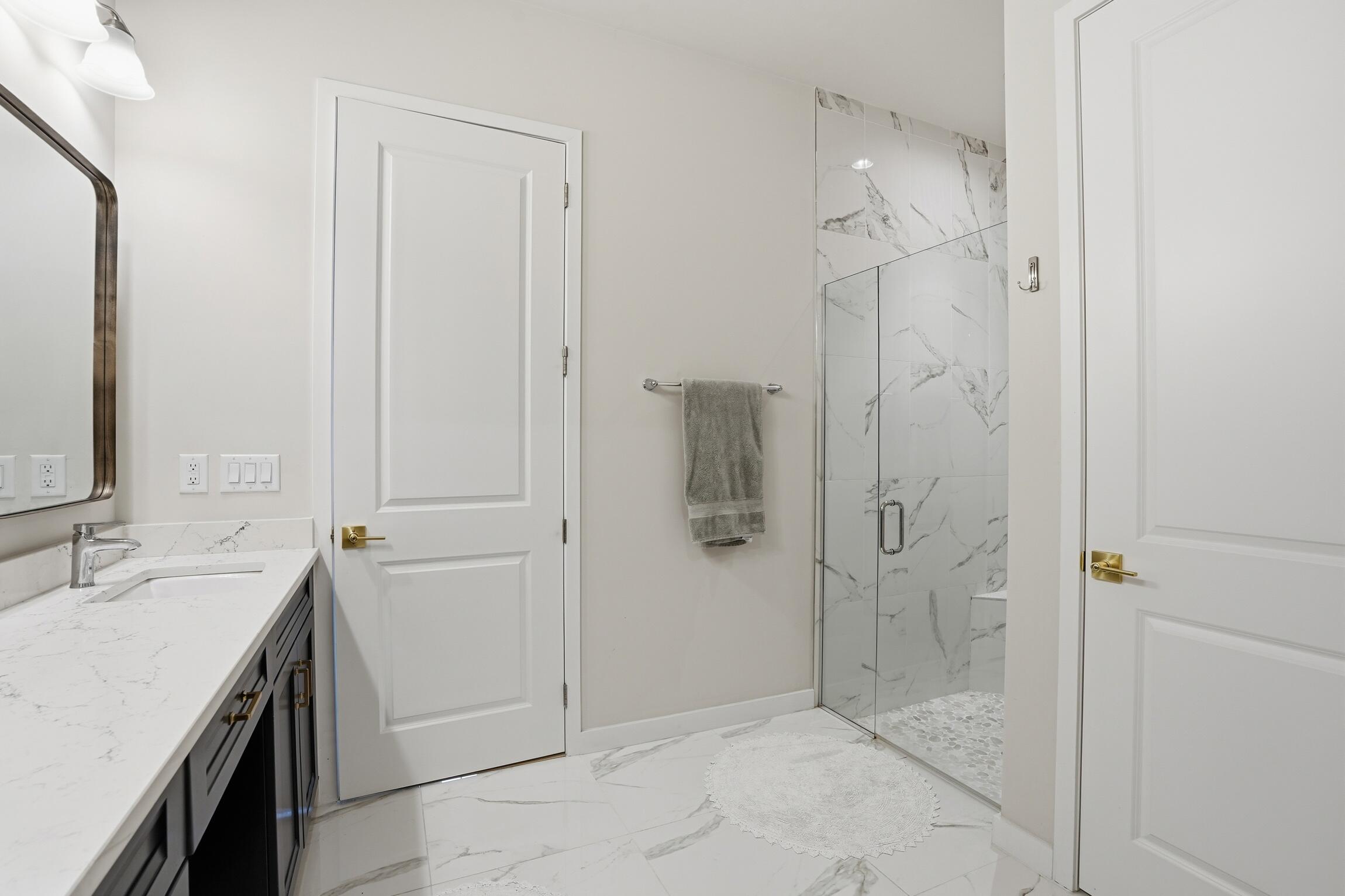 14708 Kingfisher Loop Naples, FL 34120 - Photo 24 of 42 a bathroom with a sink and shower