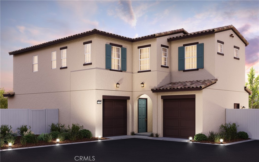 a front view of a house with plants