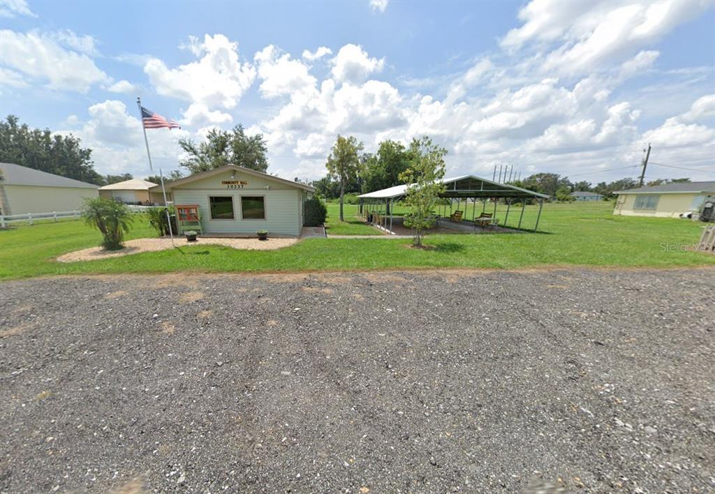 30102 Red Pine Road Punta Gorda, FL 33982 - Photo 6 of 8 a view of a house next to a big yard with plants and large trees