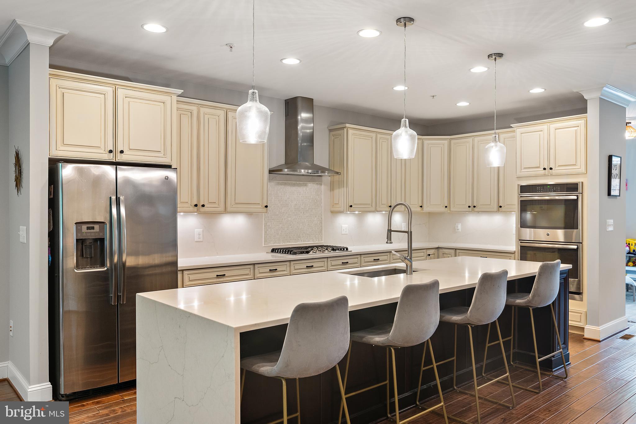 138 Merrimack Way Arnold, MD 21012 - Photo 12 of 50 a kitchen with stainless steel appliances granite countertop a dining table chairs refrigerator and cabinets