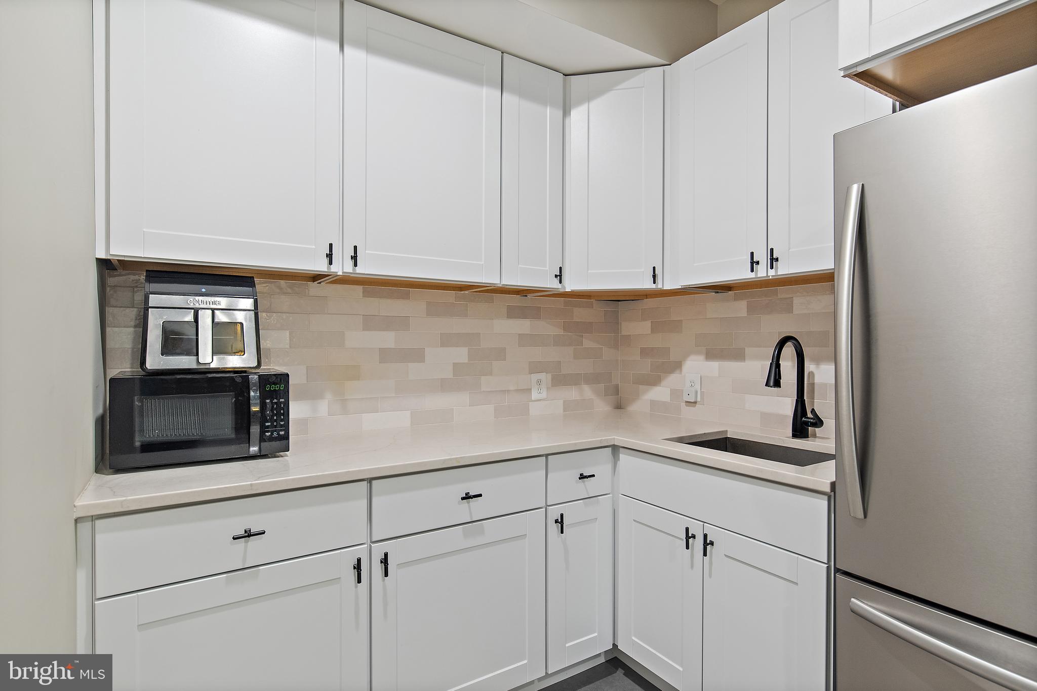 138 Merrimack Way Arnold, MD 21012 - Photo 27 of 50 a kitchen with white cabinets and white appliances