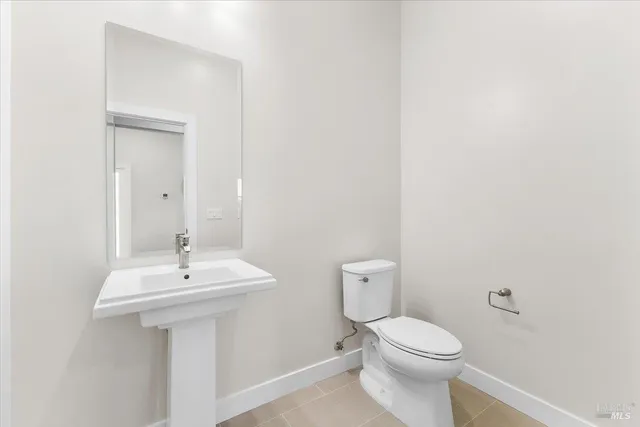 a white toilet sitting next to a bathroom sink
