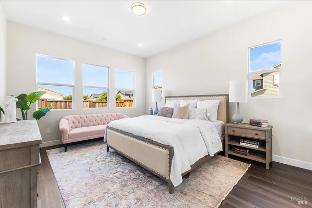 a bedroom with a bed a couch and window