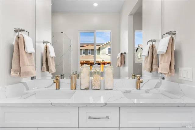 a bathroom with double vanity sink and mirror