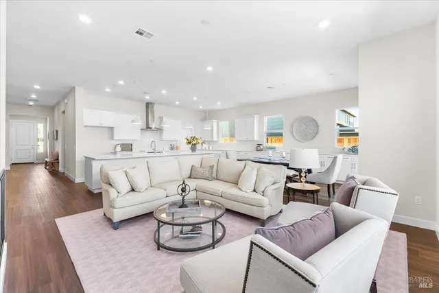 a living room with furniture and kitchen view