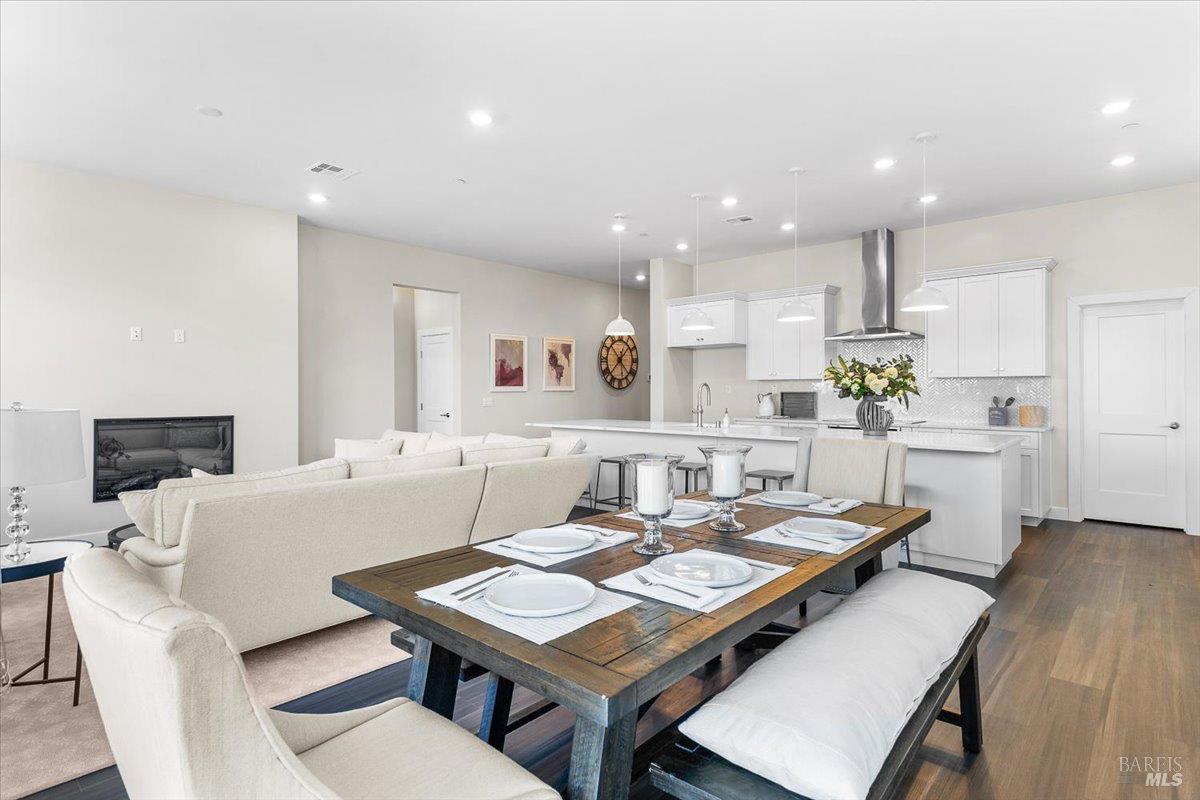 7301 Willowglen Drive Rohnert Park, CA 94928 - Photo 7 of 32 a living room with kitchen island furniture and a dining table with wooden floor