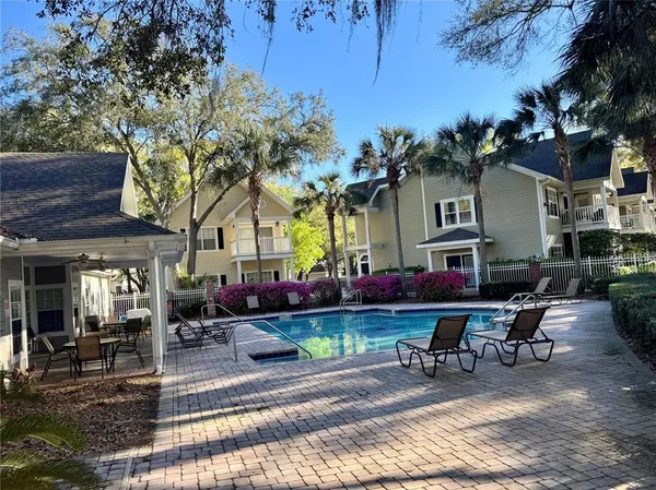a view of a house with backyard and sitting area