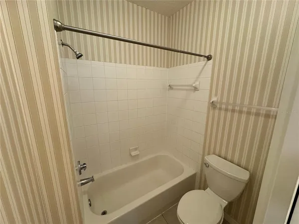 a bathroom with a toilet and a bathtub