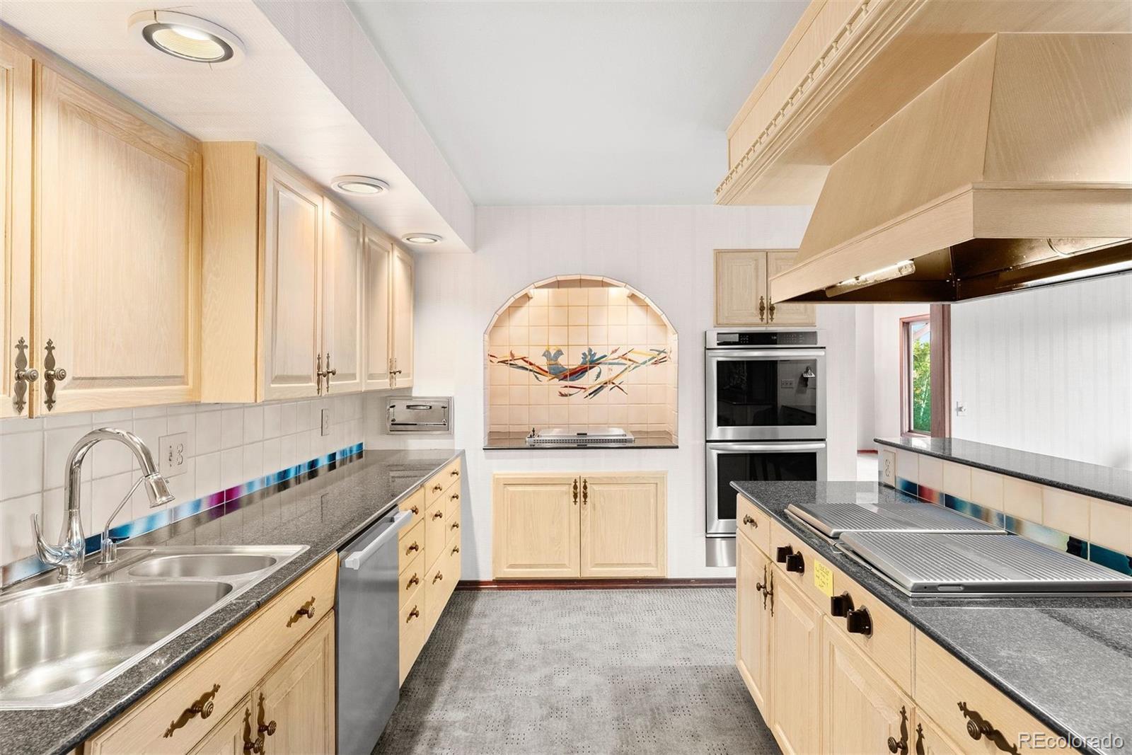 2851 Interlocken Drive Evergreen, CO 80439 - Photo 15 of 50 a kitchen with a sink stove and cabinets