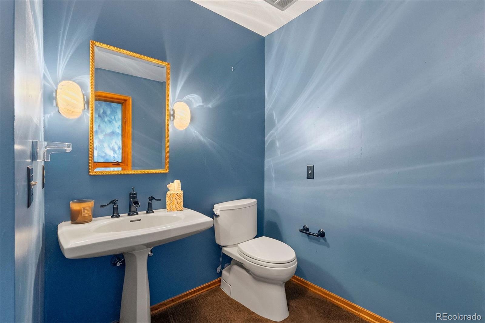 2851 Interlocken Drive Evergreen, CO 80439 - Photo 26 of 50 a bathroom with a sink mirror and toilet