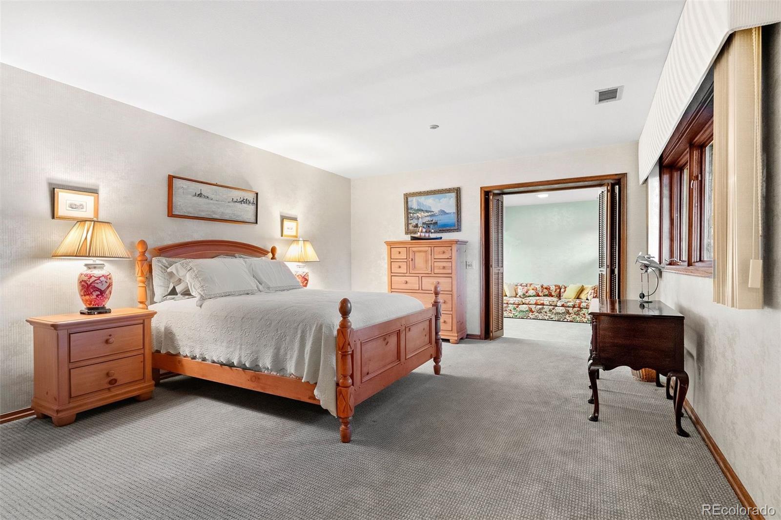 2851 Interlocken Drive Evergreen, CO 80439 - Photo 34 of 50 a bedroom with a bed couch and a window