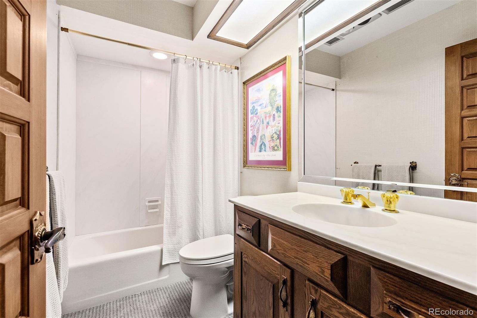 2851 Interlocken Drive Evergreen, CO 80439 - Photo 35 of 50 a bathroom with a sink a toilet and shower