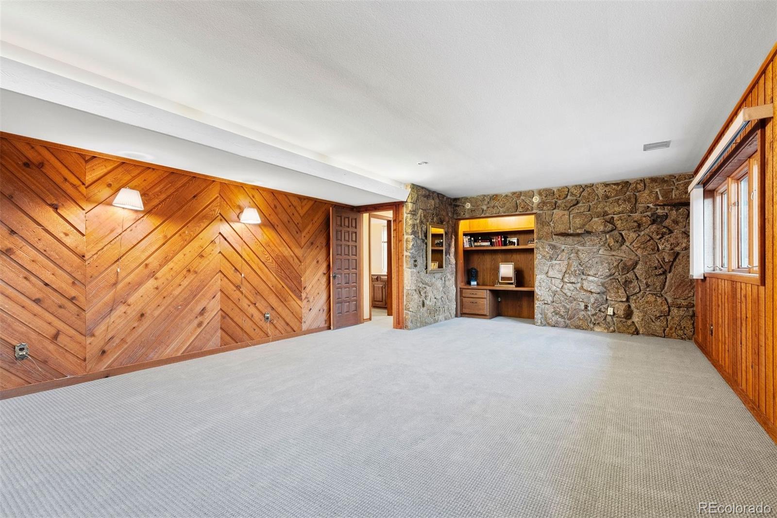 2851 Interlocken Drive Evergreen, CO 80439 - Photo 37 of 50 a view of an empty room with a fireplace and a window