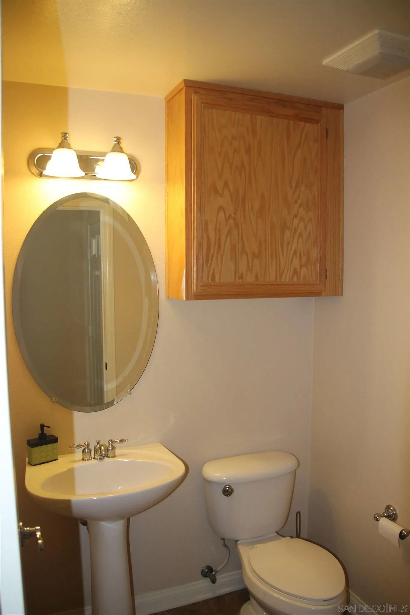 13039 Evening Creek Drive South, Unit 36 San Diego, CA 92128 - Photo 11 of 31 a bathroom with a toilet sink and mirror