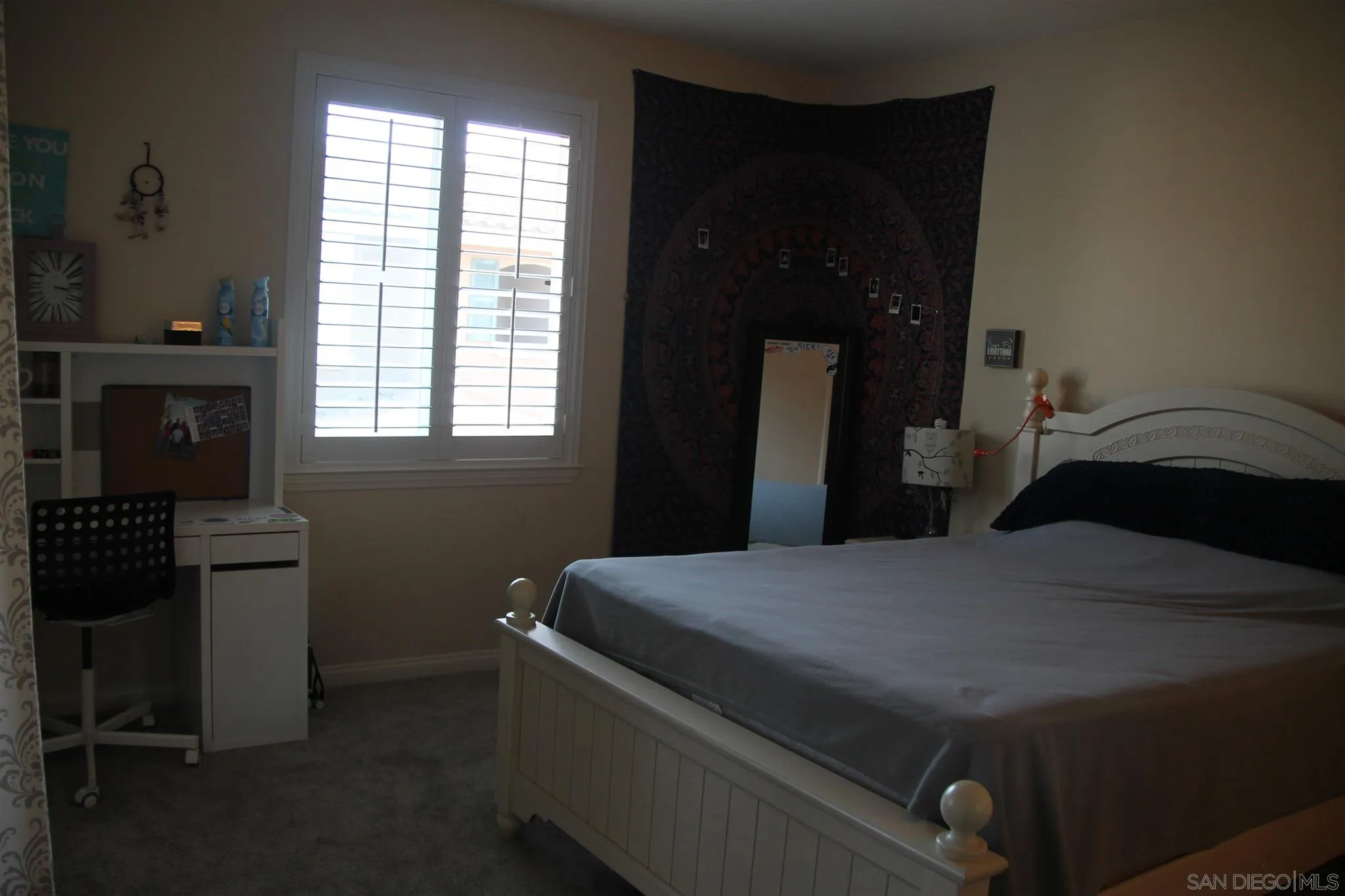 13039 Evening Creek Drive South, Unit 36 San Diego, CA 92128 - Photo 18 of 31 a bedroom with a bed and a chandelier