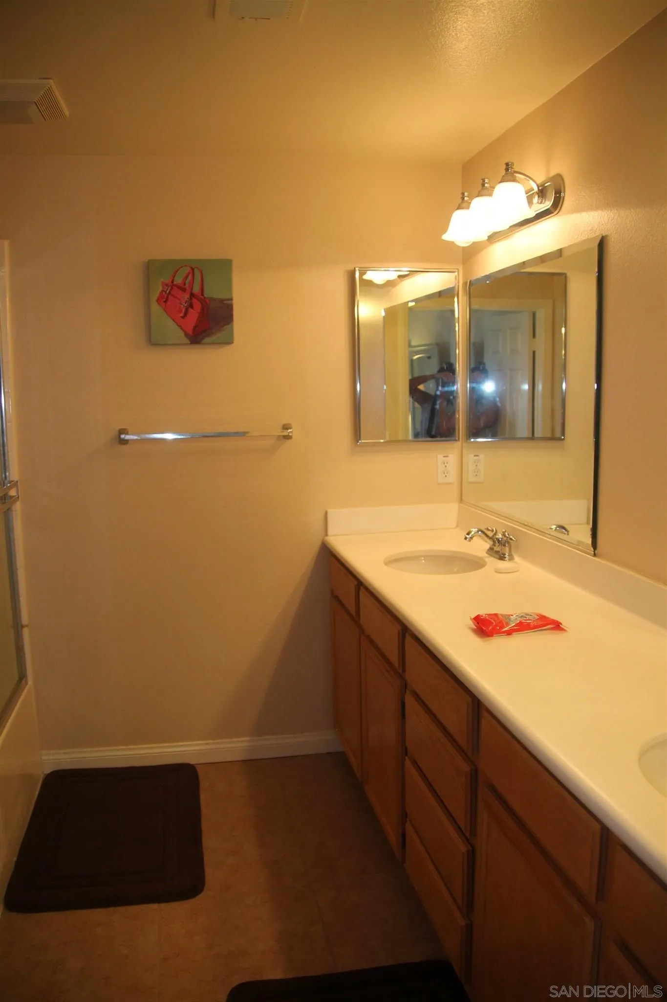 13039 Evening Creek Drive South, Unit 36 San Diego, CA 92128 - Photo 19 of 31 a bathroom with a sink and a large mirror