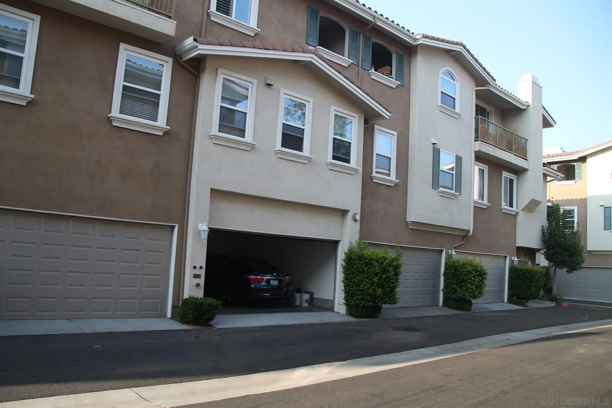 13039 Evening Creek Drive South, Unit 36 San Diego, CA 92128 - Photo 2 of 31 a front view of a house with a street