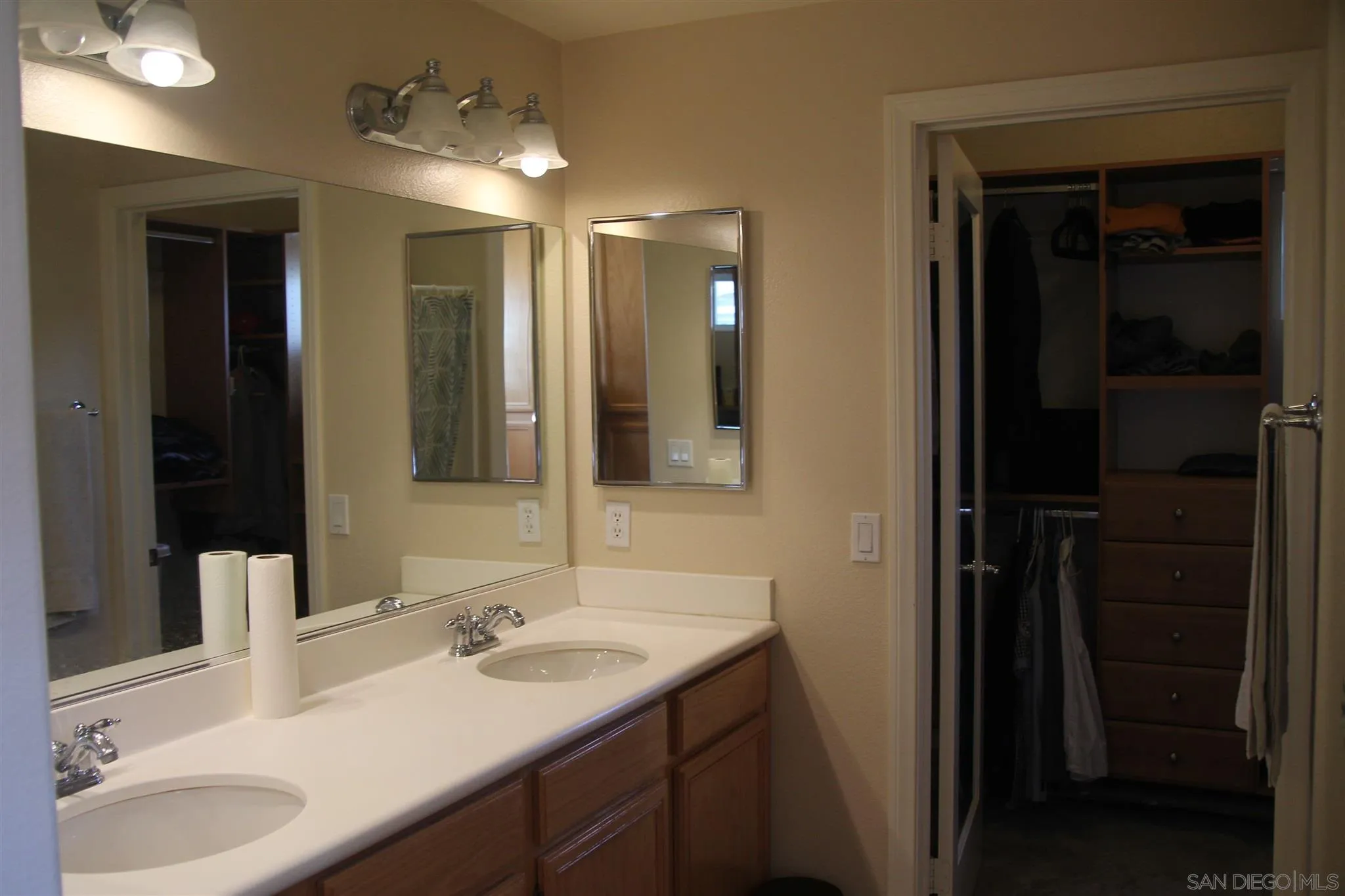 13039 Evening Creek Drive South, Unit 36 San Diego, CA 92128 - Photo 23 of 31 a bathroom with a sink and a mirror