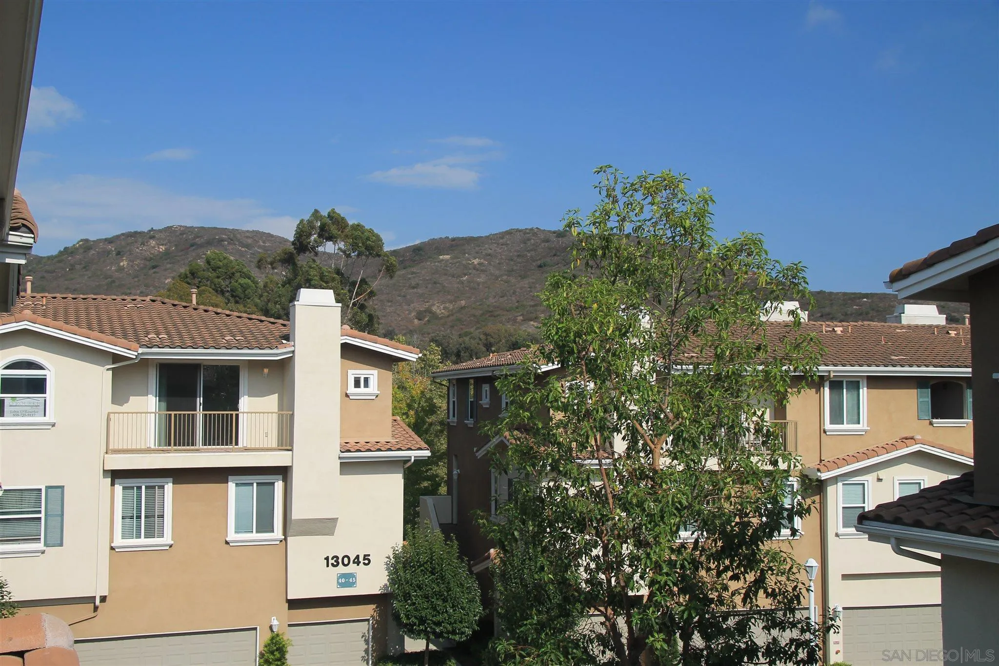 13039 Evening Creek Drive South, Unit 36 San Diego, CA 92128 - Photo 25 of 31 a view of residential houses with a yard