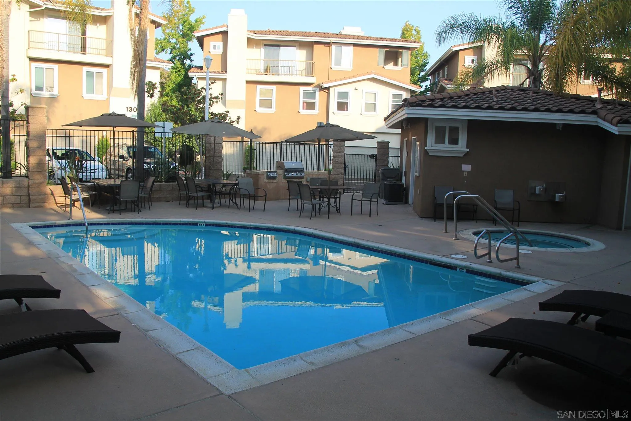 13039 Evening Creek Drive South, Unit 36 San Diego, CA 92128 - Photo 27 of 31 a view of a swimming pool with outdoor seating