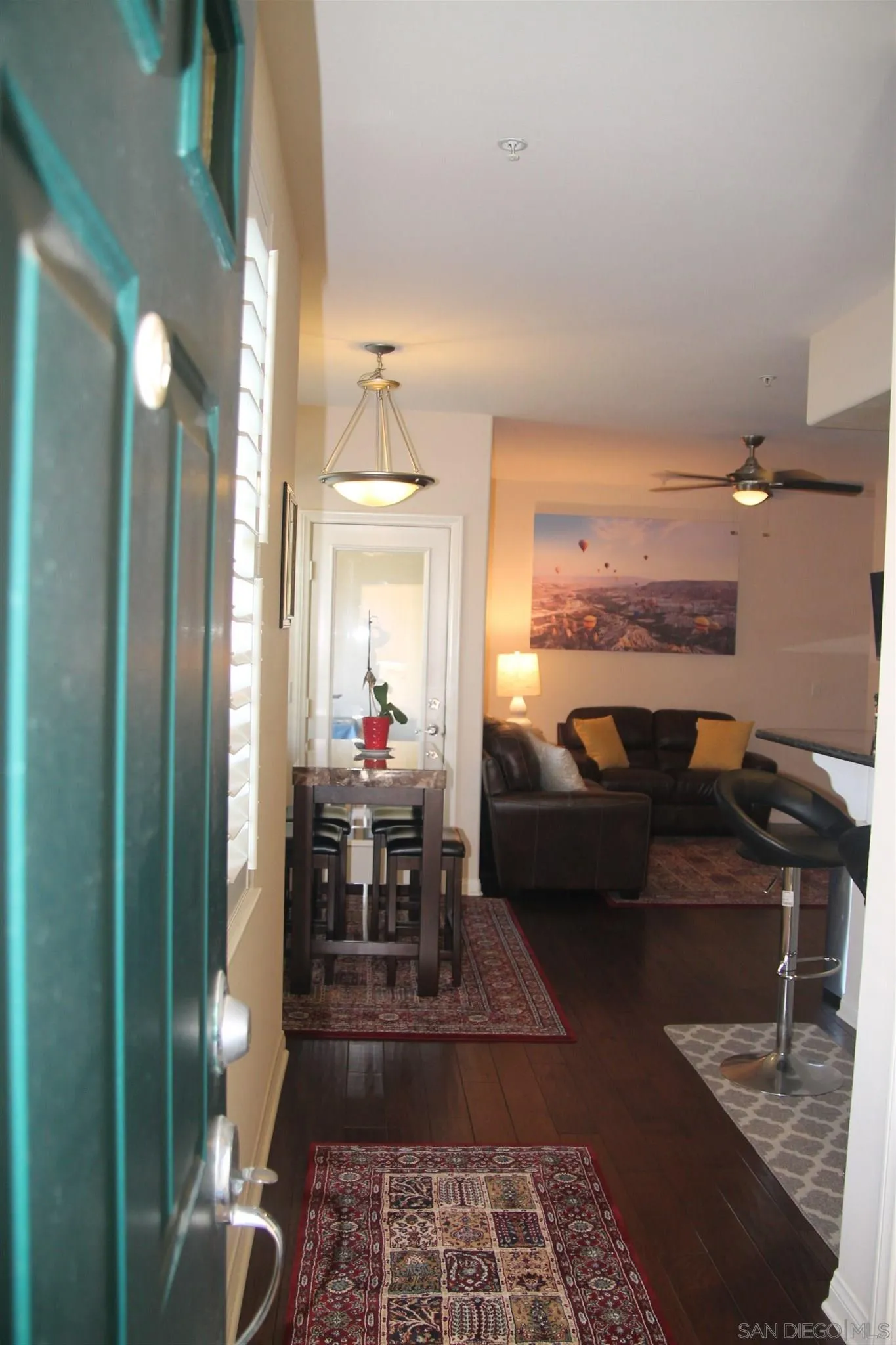 13039 Evening Creek Drive South, Unit 36 San Diego, CA 92128 - Photo 29 of 31 a living room with furniture and a lamp