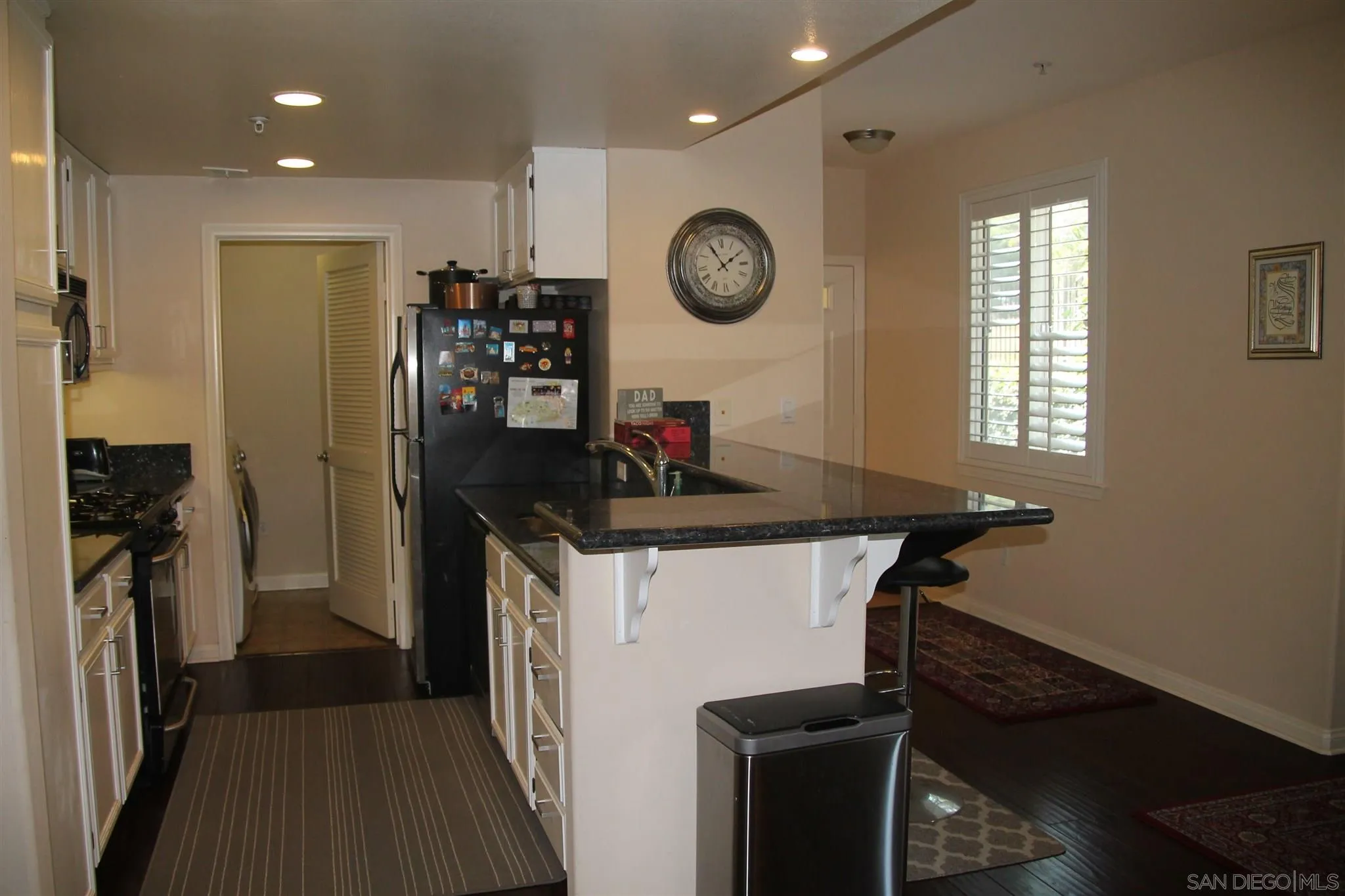 13039 Evening Creek Drive South, Unit 36 San Diego, CA 92128 - Photo 3 of 31 a kitchen with a refrigerator and a stove top oven