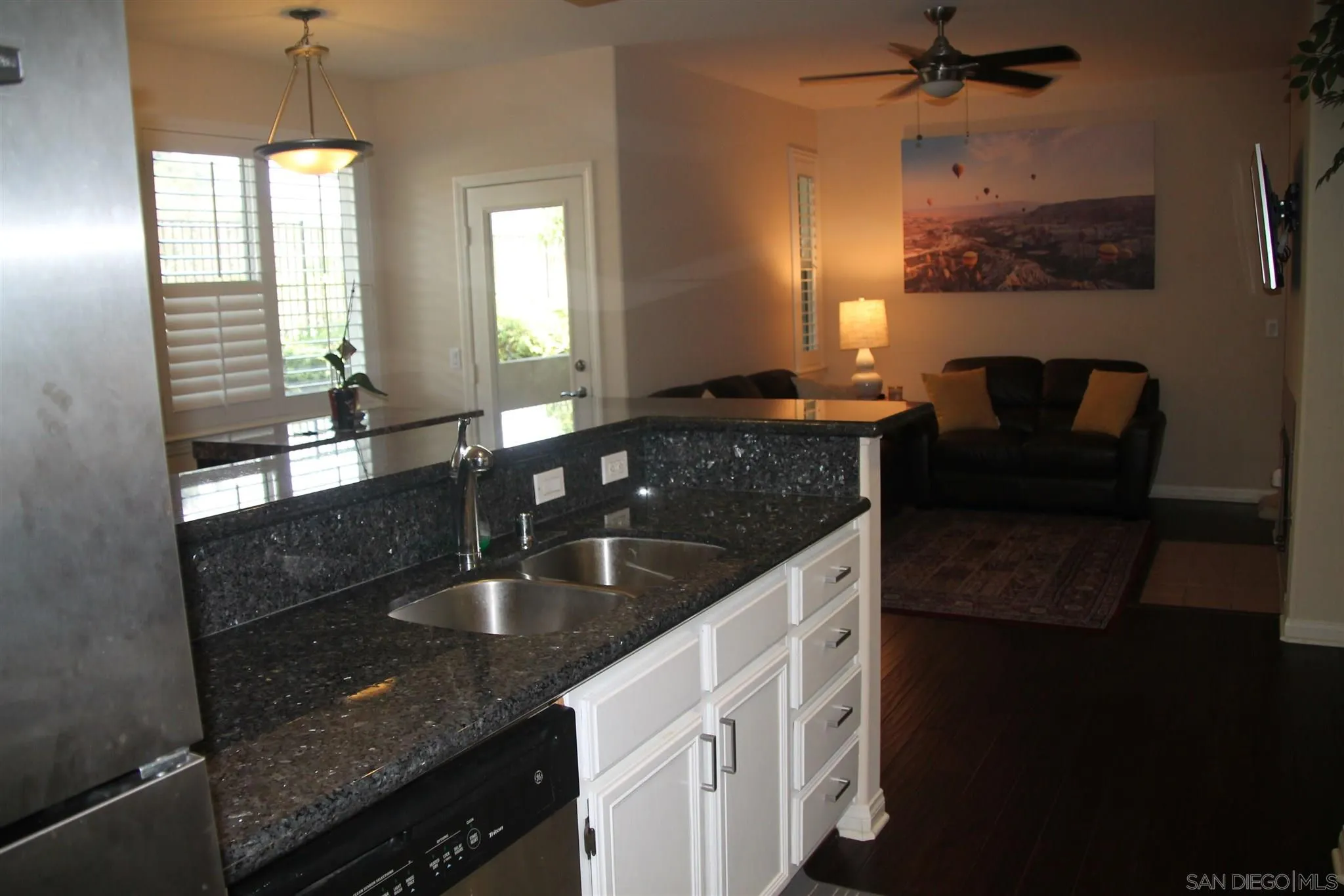 13039 Evening Creek Drive South, Unit 36 San Diego, CA 92128 - Photo 6 of 31 a kitchen with granite countertop a sink a counter top space and cabinets