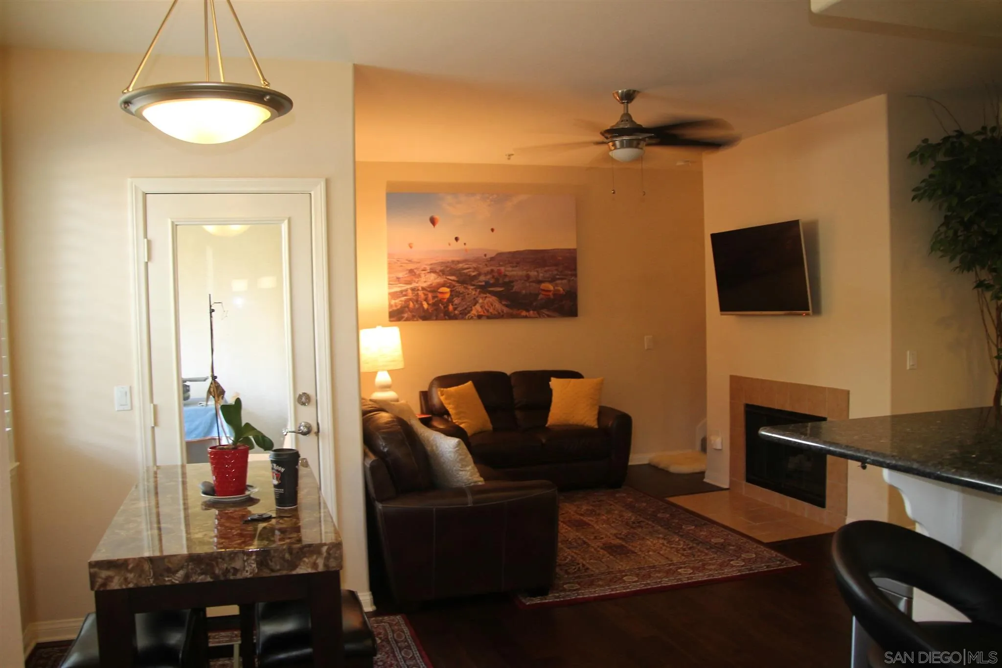 13039 Evening Creek Drive South, Unit 36 San Diego, CA 92128 - Photo 7 of 31 a living room with furniture and a flat screen tv