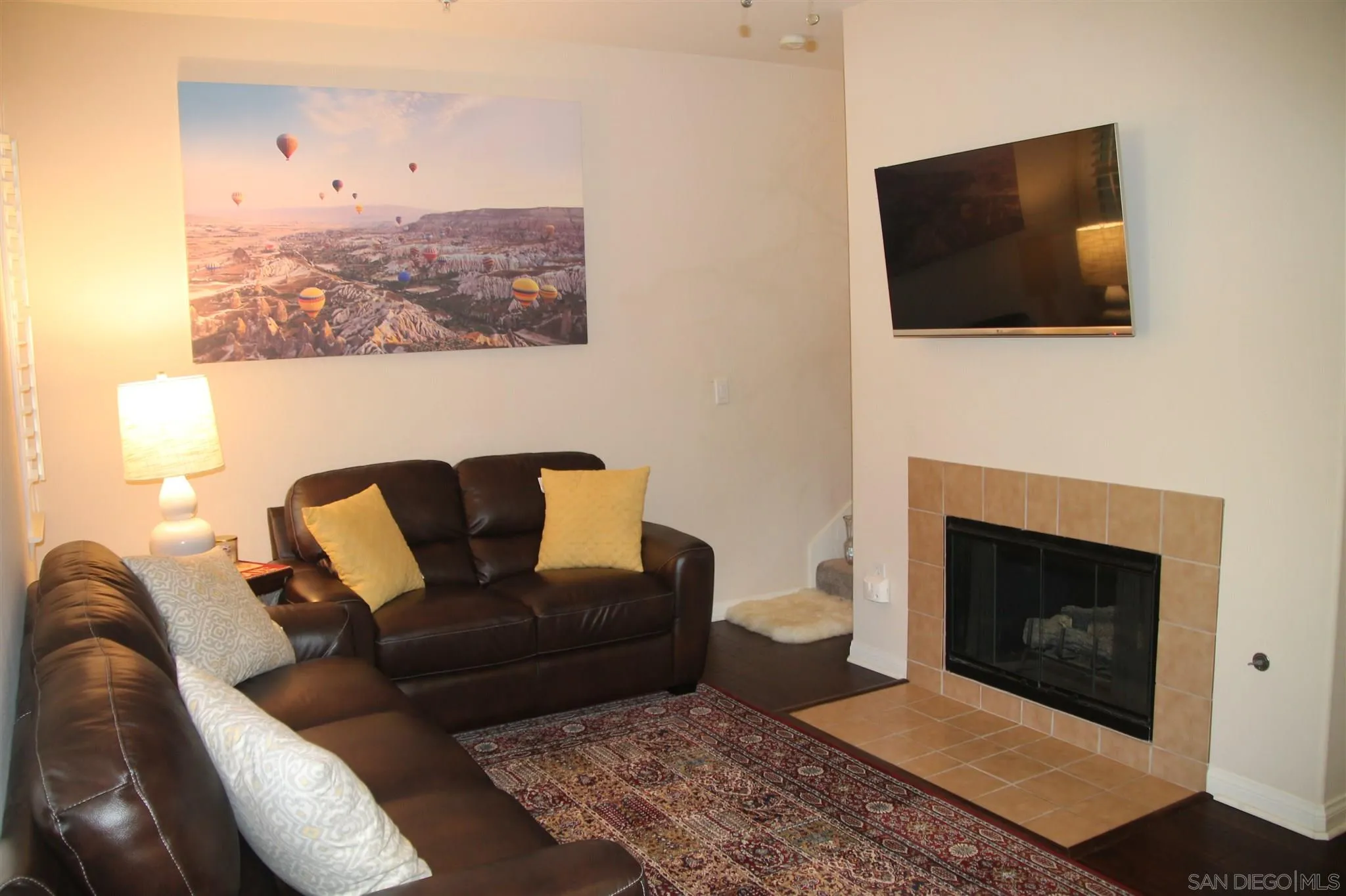 13039 Evening Creek Drive South, Unit 36 San Diego, CA 92128 - Photo 8 of 31 a living room with furniture and a fireplace