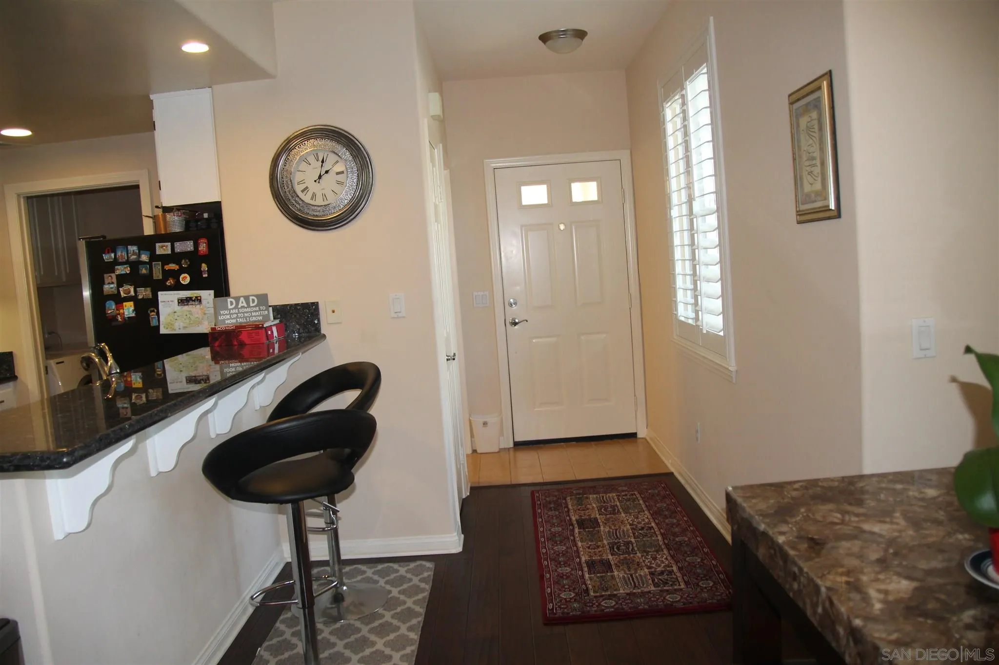 13039 Evening Creek Drive South, Unit 36 San Diego, CA 92128 - Photo 10 of 31 a bedroom with a bed and a chandelier