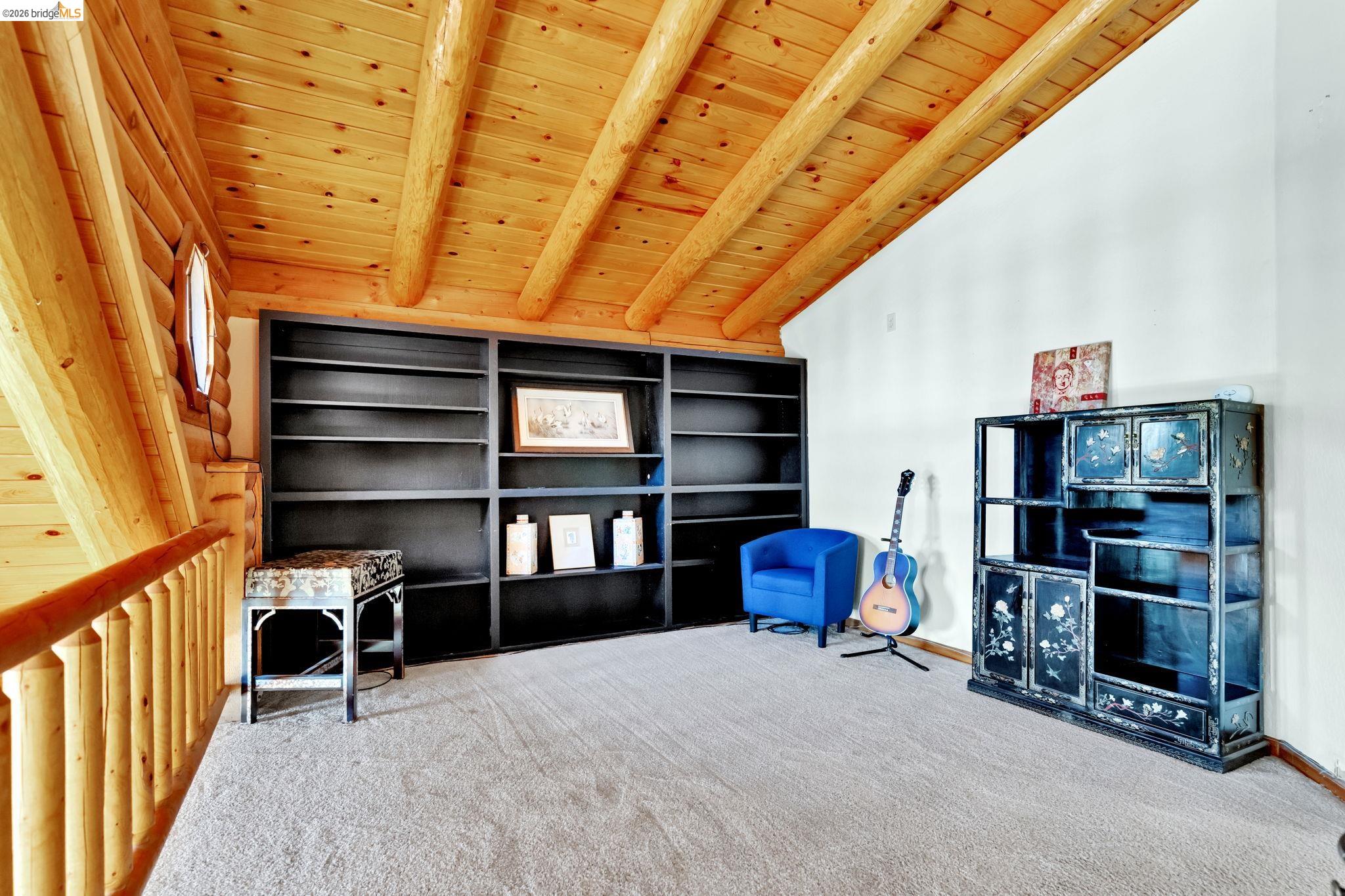 14799 Big Hill Road Sonora, CA 95370 - Photo 27 of 60 Living area with wooden ceiling, light carpet, and vaulted ceiling with beams
