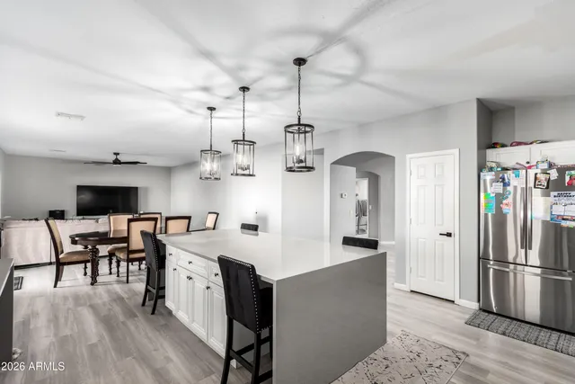 a view of a kitchen and kitchen island with wooden floor