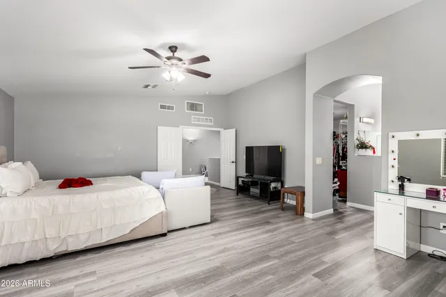 a bedroom with a bed and a flat screen tv