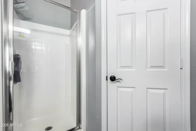 a bathroom with a glass shower door