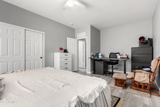 a bedroom with a bed and a desk