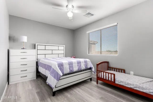 a bedroom with a bed and a dresser