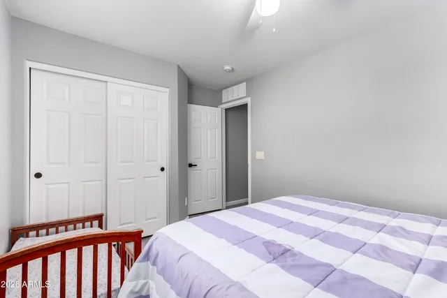 a bedroom with a bed and a window