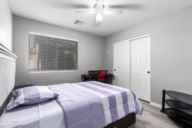 a bedroom with a bed and a chandelier