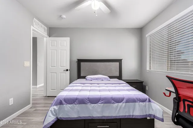 a bedroom with a bed and a book shelf