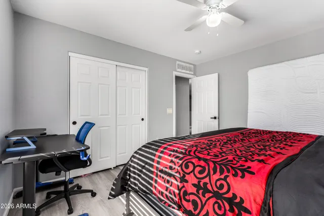 a bedroom with a bed and a chandelier