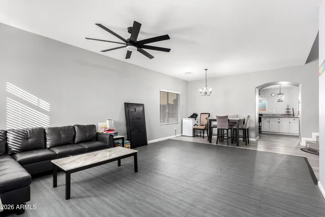 a living room with furniture and a view of kitchen