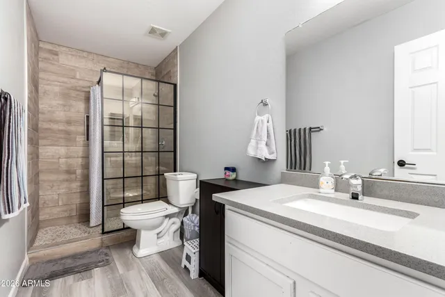 a bathroom with a sink toilet and shower