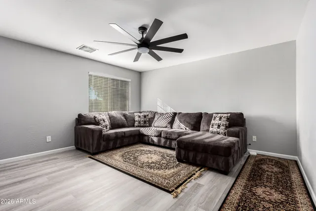 a living room with furniture and a rug