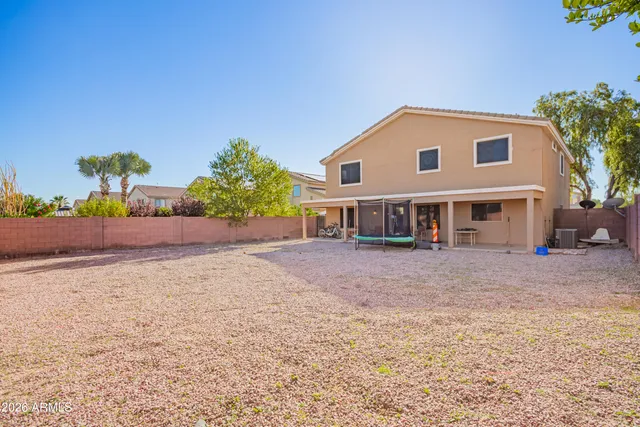 a front view of a house with a yard and a garage
